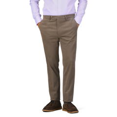 A person wearing a light purple shirt, Berwich Muted Olive Cotton Moleskin Trousers, and brown shoes stands with hands in pockets against a plain background.