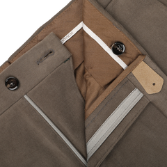 Close-up of Berwich Muted Olive Cotton Moleskin Trousers showing the inside waistband, button closures, a brand label, and a striped lining detail.