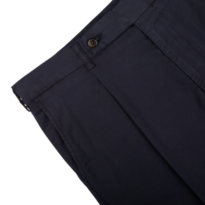 Close-up of Berwich navy blue cotton blend pleated shorts with a button closure and pleat detail.