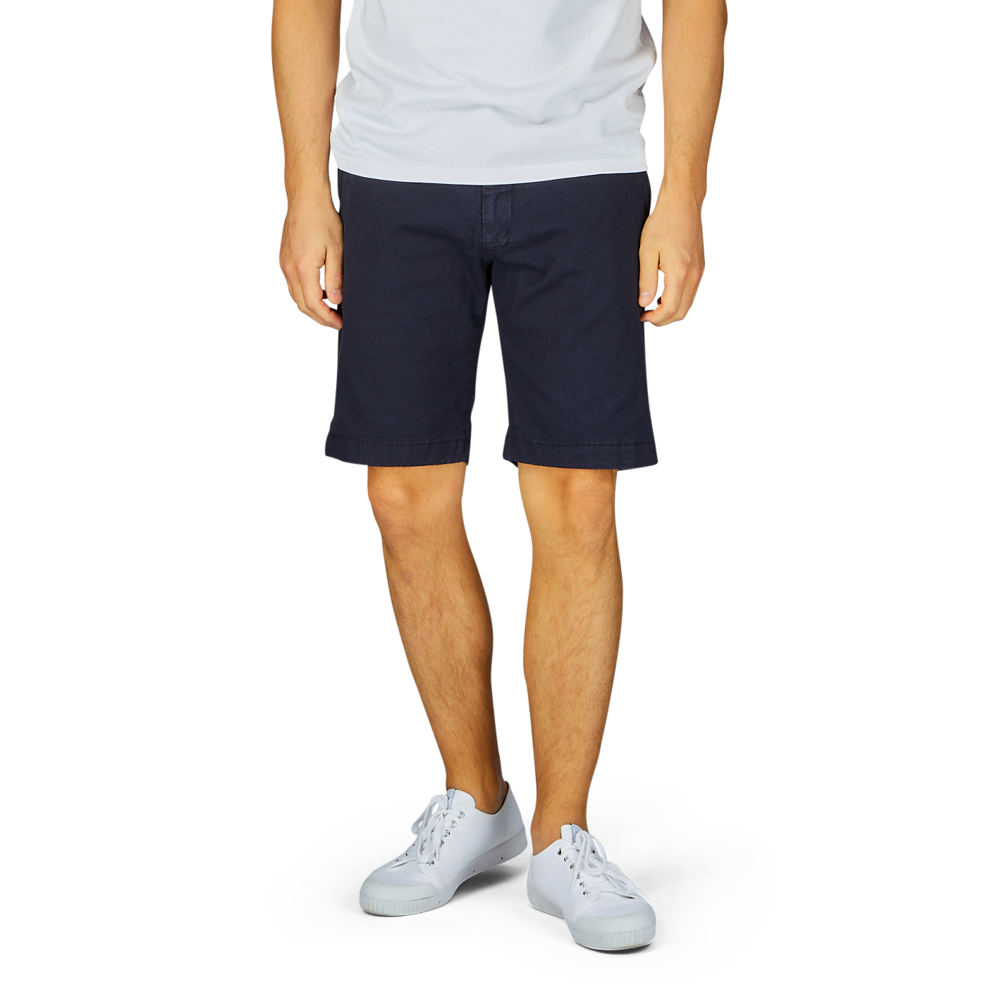 Man wearing Berwich navy blue cotton stretch Bermuda shorts and white sneakers standing against a light background, ready for summer vacation.