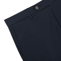 Close-up of a pair of Navy Blue Cotton Twill Flat Front Trousers featuring a waistband with belt loops, a button closure, and a visible pocket. The Berwich Vulcano fit pants are made from soft cotton twill for added comfort and durability.