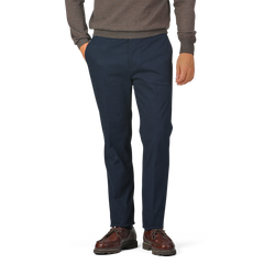 A person wearing a brown sweater, Navy Blue Cotton Twill Flat Front Trousers from Berwich, and brown shoes stands with their hands in their pockets against a plain background.