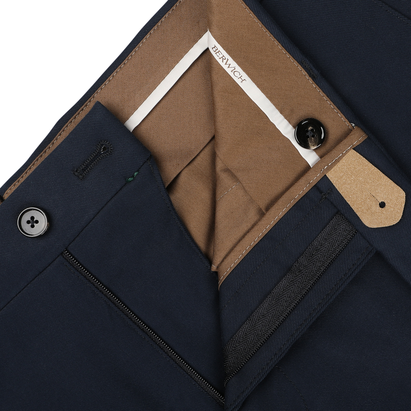 A close-up view of the Navy Blue Cotton Twill Flat Front Trousers reveals the inside waistband and zipper area, exposing a brown inner lining and a label that says "Berwich." Crafted from cotton twill, these pants boast the Vulcano fit for optimal comfort.