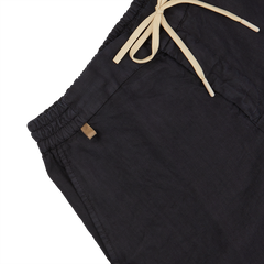 Close-up of Berwich Navy Blue Washed Linen Drawstring Shorts with elastic waistband on a white background.