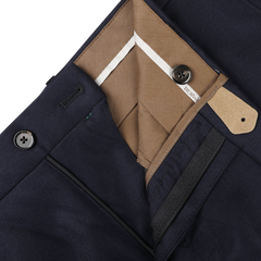 Close-up of the interior waistband and zipper area of the Berwich Navy Blue Wool Flannel Flat Front Trousers, showcasing buttons, a hook closure, and beige lining. Crafted from pure wool flannel for ultimate comfort.