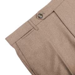 Close-up of Berwich's Oatmeal Melange Wool Flannel Flat Front Trousers in a Vulcano fit, showcasing a button and belt loop on a white background.