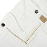 Close-up of a white Berwich jacket with a zipper, buttons, and Off-White Cotton Blend Pleated Shorts.