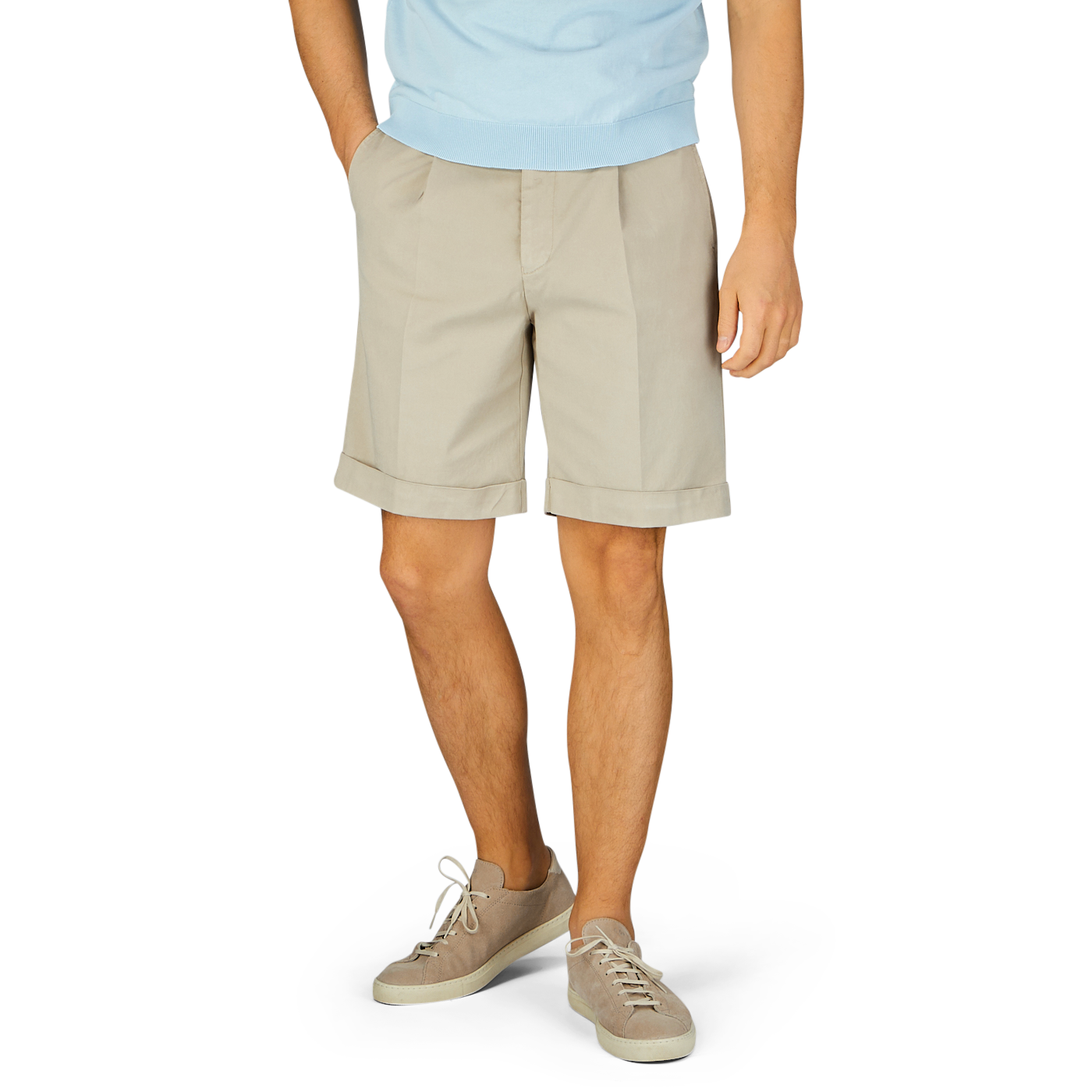 A person wearing Berwich Sabbia Beige Cotton Blend Pleated Shorts and casual shoes against a blue background.