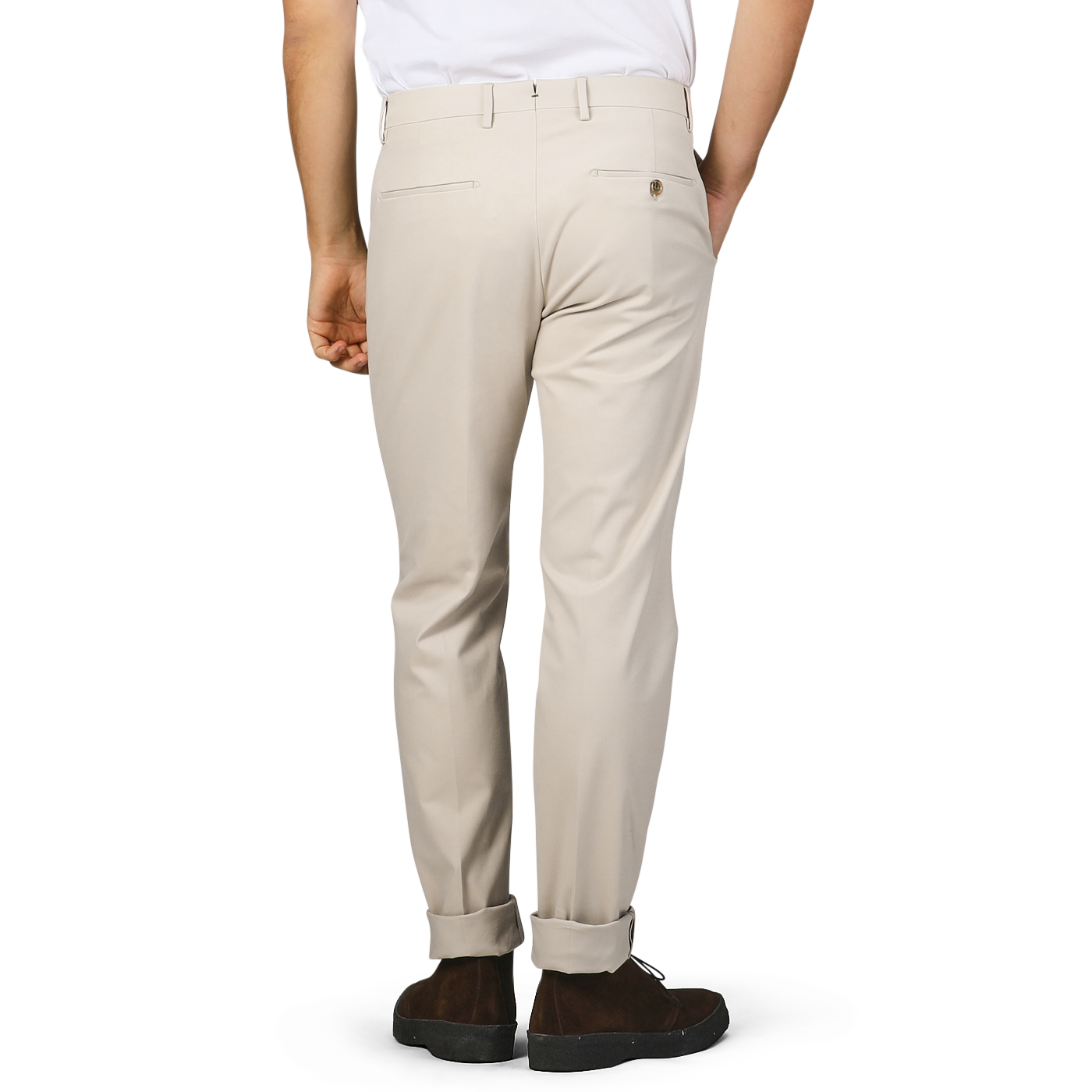 A person is wearing the Sand Beige Cotton Twill Flat Front Trousers from Berwich, paired with a white shirt in the Vulcano fit. They are standing with one hand in their pocket, facing away.