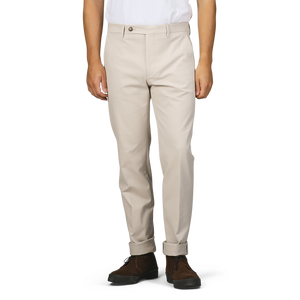 An individual dressed in Sand Beige Cotton Twill Flat Front Trousers by Berwich is standing upright with their arms at their sides, teamed with a white shirt and brown shoes.