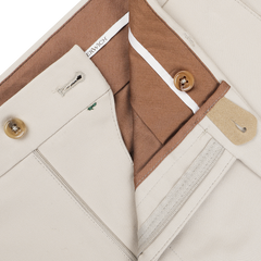 Close-up of Berwich's Sand Beige Cotton Twill Flat Front Trousers, showcasing the Vulcano fit with brown interior lining, buttons, and a label on the waistband.