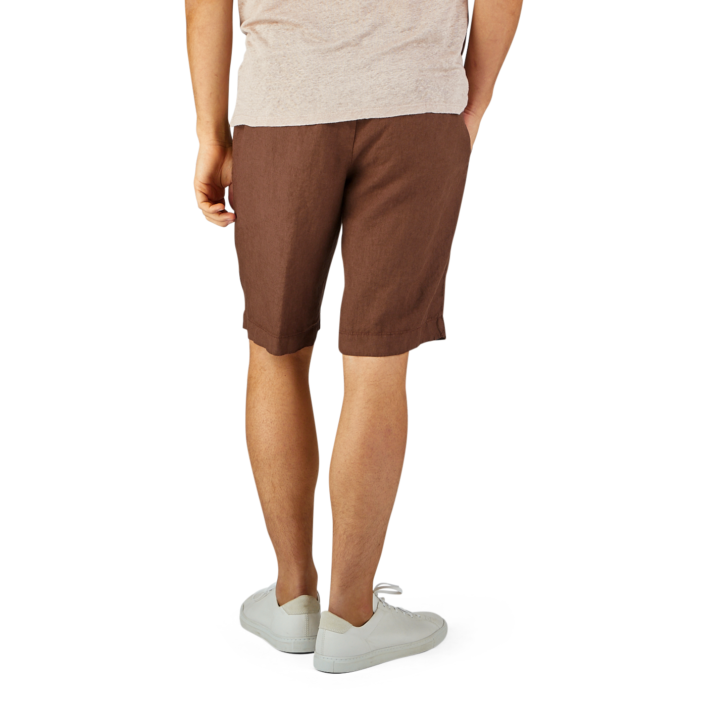 A man wearing a light beige T-shirt and Berwich's Terra Brown Washed Linen Drawstring Shorts, standing with white sneakers on a plain background.