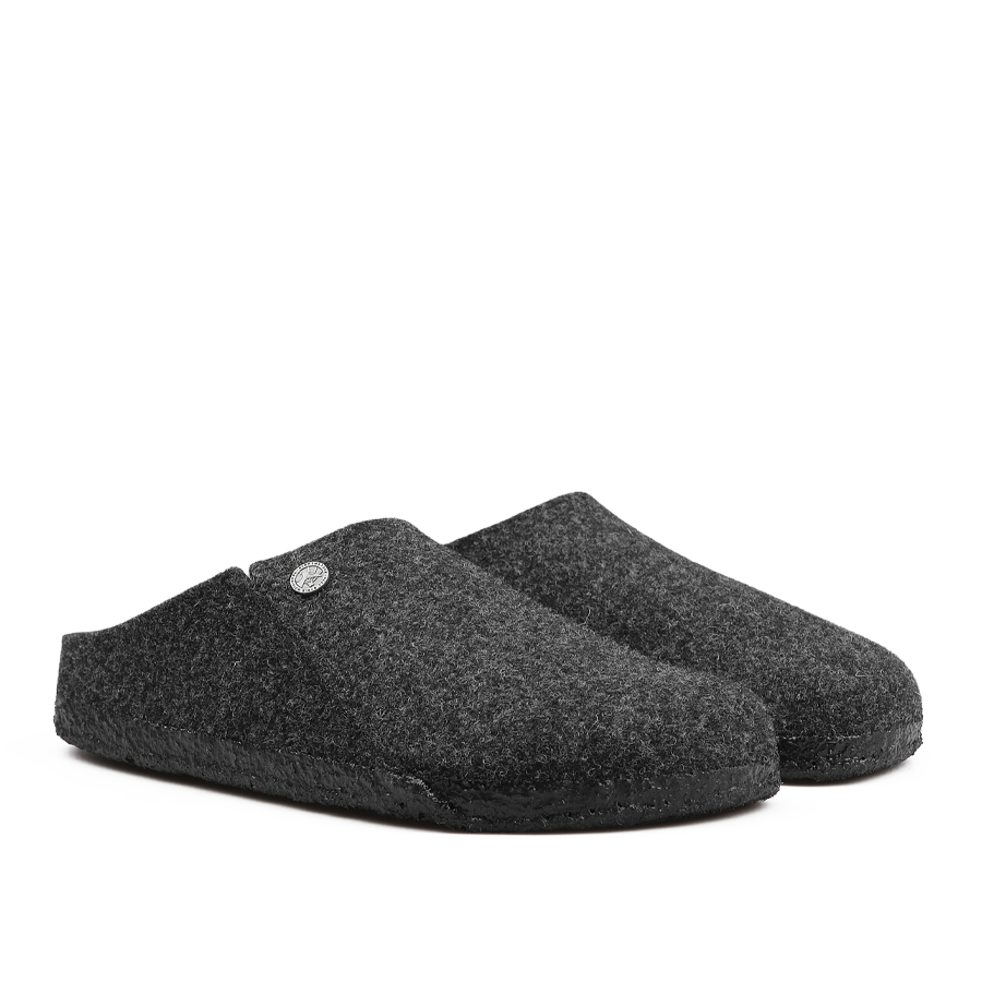 A pair of Anthracite Grey Zermatt Rivet Slippers by Birkenstock, featuring wool felt material, black rubber soles, and removable footbeds, positioned side by side.