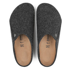 The Anthracite Grey Zermatt Rivet Slippers by Birkenstock, featuring brown insoles and a removable footbed, offer the perfect solution for indoor comfort.