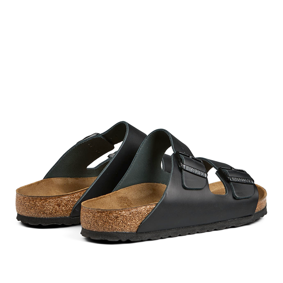 A pair of Birkenstock Black Natural Leather Arizona Sandals with cork soles and adjustable straps.