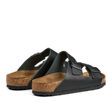 A pair of Birkenstock Black Natural Leather Arizona Sandals with cork soles and adjustable straps.