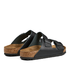 A pair of Birkenstock Black Natural Leather Arizona Sandals with cork soles and adjustable straps.