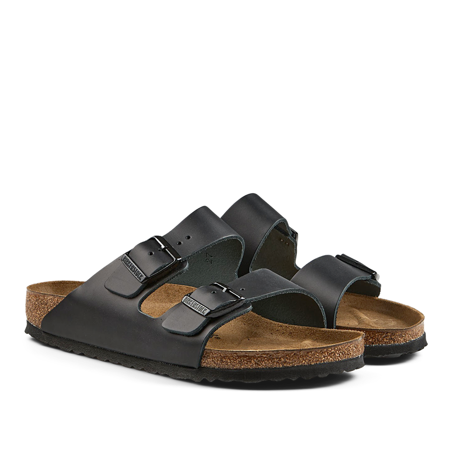 A pair of Black Natural Leather Arizona Sandals with cork soles by Birkenstock.