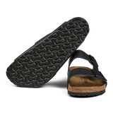A black Birkenstock sandal with a cork footbed and a pronounced tread pattern on the sole.