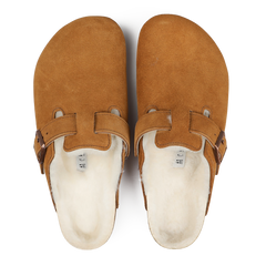 A pair of Mink Brown Suede Shearling Lined Boston Slippers by Birkenstock, featuring slip-on design with open backs and leather straps.