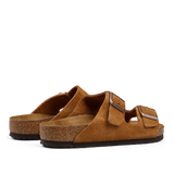 A pair of Mink Brown Suede Leather Birkenstock Arizona sandals with adjustable straps and cork footbeds.