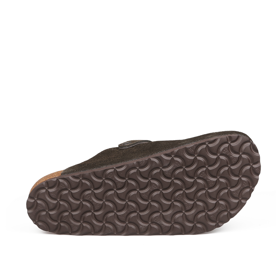 The image shows the sole of a Birkenstock Mocca Brown Suede Shearling Lined Boston Slipper, featuring a wavy textured rubber underside and crafted from dark suede with a signature cork footbed for comfort.