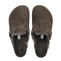 A pair of Mocca Brown Suede Shearling Lined Boston Slippers by Birkenstock with buckle straps and a comfortable footbed, featuring slip-on clogs design with fur lining.