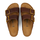 A pair of Roast Bold Natural Leather Birkenstock Arizona Sandals featuring two gold buckles on each natural leather upper strap and cork footbeds with anatomically-supported footbeds. Size details printed on the inner sole.