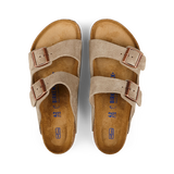 A pair of Taupe Beige Suede Leather Birkenstock Arizona Sandals displayed on a black background.