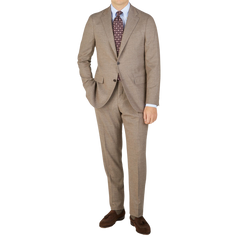 A man in a Beige Grey Wool Flannel Boglioli suit is posing for a photo, showcasing understated elegance.