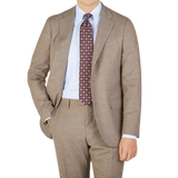 A man is posing in a seasonal Boglioli Beige Grey Wool Flannel K Suit.