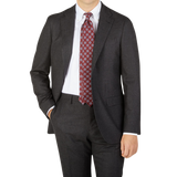 A man is posing in a Boglioli Charcoal Grey Wool Flannel K Suit and tie.