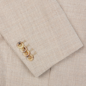 A close-up of a Boglioli Cream Beige Wool Hopsack K Jacket with buttons showcases its unstructured craftsmanship.