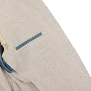 A close up of a Boglioli Cream Beige Wool Hopsack K Jacket suit with a blue pocket showcasing fine craftsmanship.