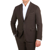 A man wearing a Boglioli Dark Brown Washed Linen Suit, exuding understated elegance.