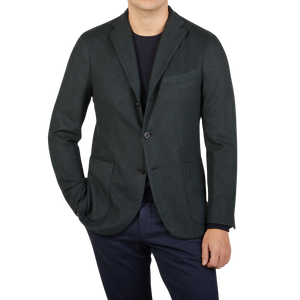 An unstructured Boglioli Green Herringbone Wool K Jacket made in Italy, worn by a man sporting a green blazer and black pants.
