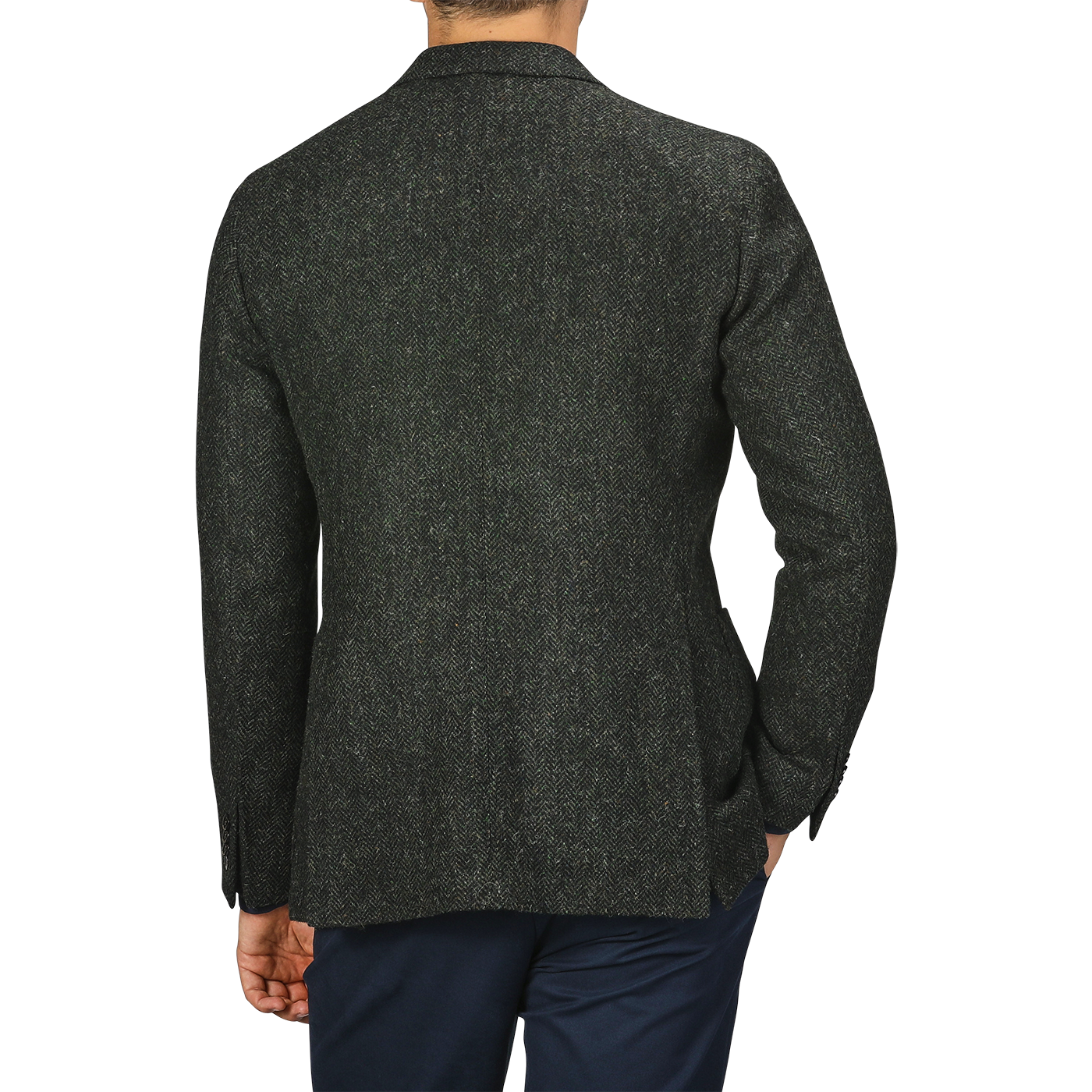 A person wearing a green herringbone wool tweed K Jacket by Boglioli and navy pants, showcasing unstructured craftsmanship, photographed from the back.