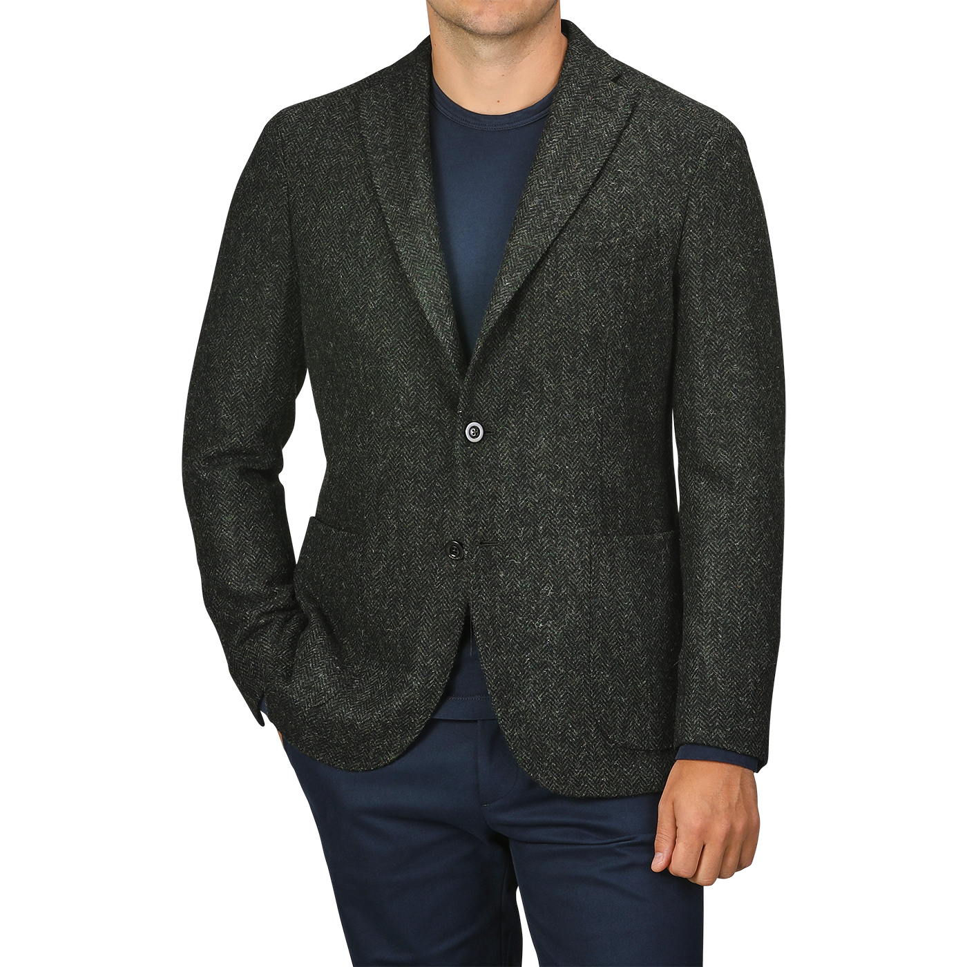 A person wearing a Green Herringbone Wool Tweed K Jacket by Boglioli over a navy shirt and navy pants, with their hands in their pockets.