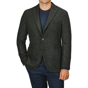 A person wearing a Green Herringbone Wool Tweed K Jacket by Boglioli over a navy shirt and navy pants, with their hands in their pockets.