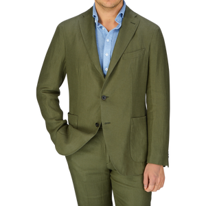 Man in olive green Boglioli Green Washed Irish Linen K Jacket with blue linen shirt, no tie, white background.