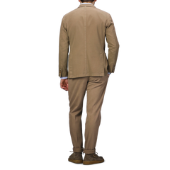 The individual, dressed in the Khaki Beige Heavy Cotton Twill Suit by Boglioli, stands with their back to the camera, accented by brown shoes.