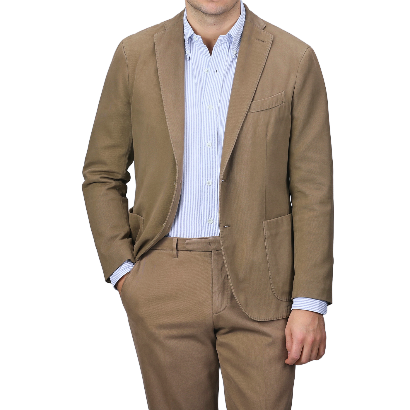 A person in a Boglioli Khaki Beige Heavy Cotton Twill Suit, paired with a blue and white striped shirt, stands with one hand in their pocket.