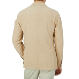 The skilled craftsmanship of a Boglioli K Jacket is evident in the design of this tan Boglioli jacket, which is showcased from the back view on a man.