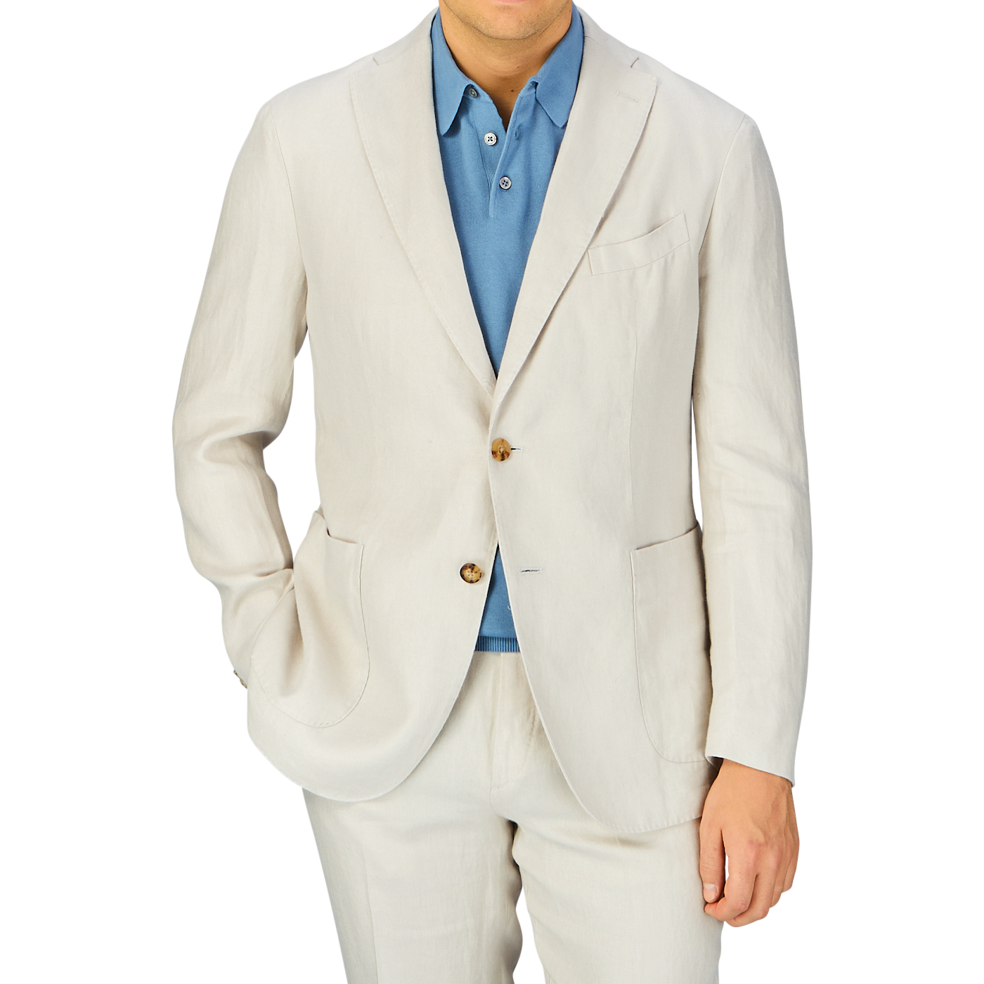 A man wearing a Light Beige Washed Irish Linen K Jacket from Boglioli, unstructured in its craftsmanship, with a blue shirt buttoned up but without a tie.