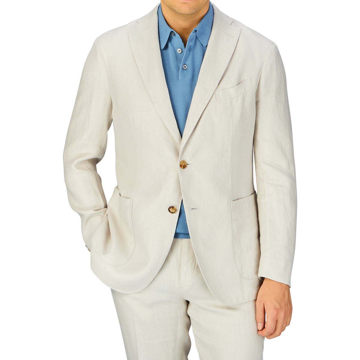 A man wearing a Light Beige Washed Irish Linen K Jacket from Boglioli, unstructured in its craftsmanship, with a blue shirt buttoned up but without a tie.