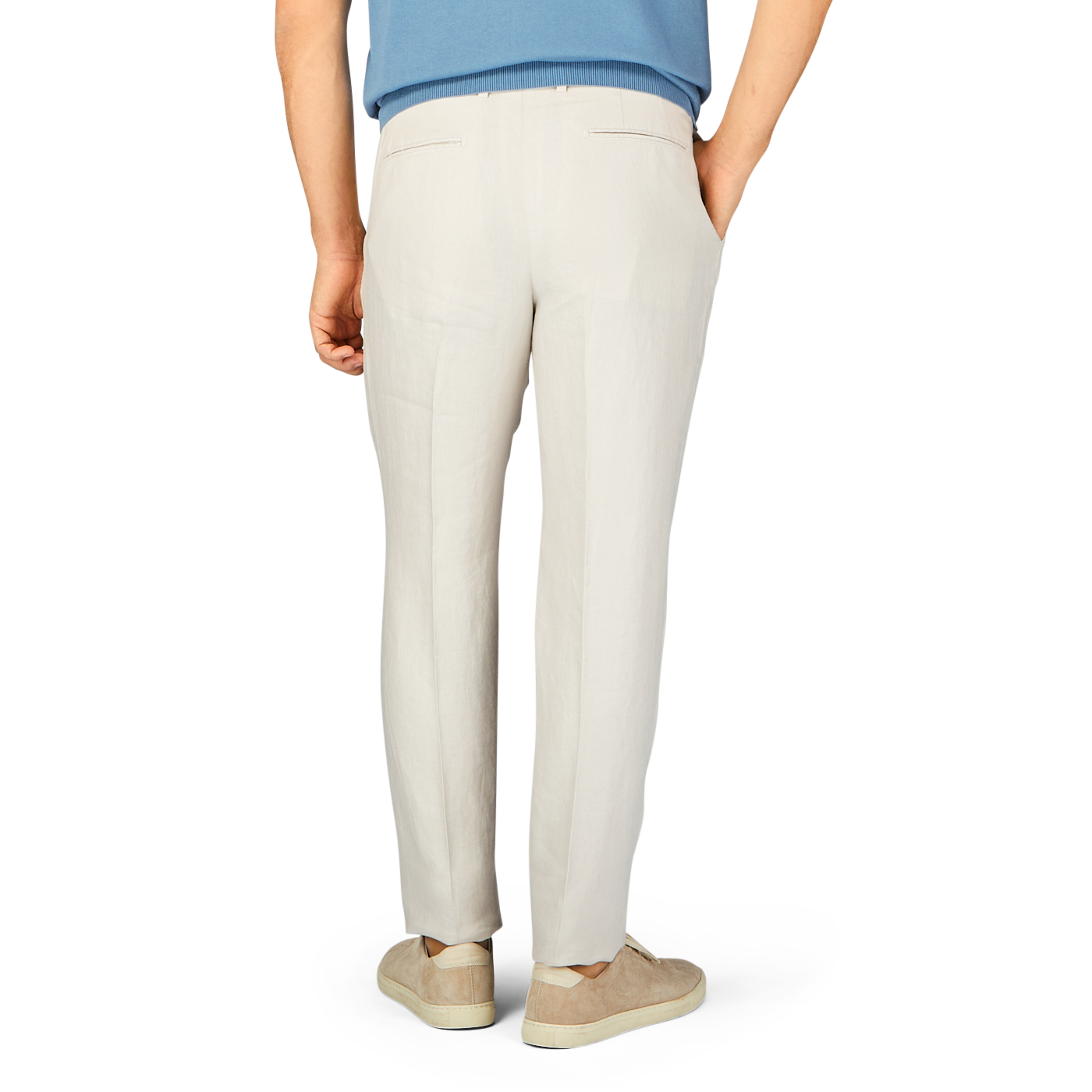 Person standing with their back to the camera showcasing a pair of Boglioli Light Beige Washed Irish Linen Trousers and beige shoes.