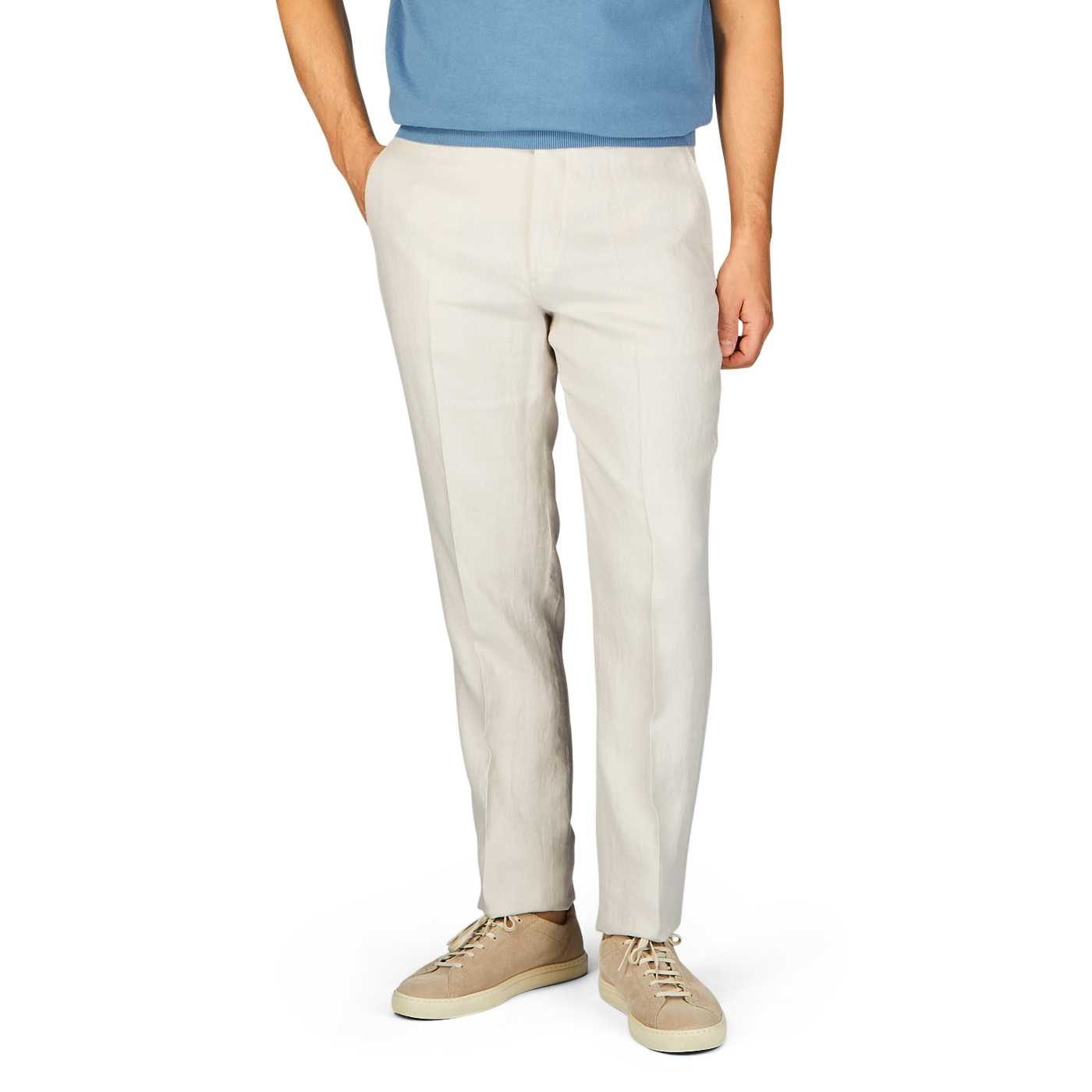 A person wearing light beige washed Irish linen Boglioli trousers paired with a blue t-shirt and beige shoes, cropped at the waist.