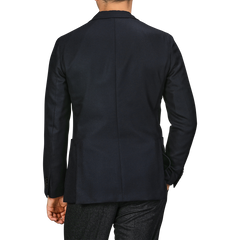 A man is seen from behind, wearing a Navy Blue Virgin Wool K Jacket by Boglioli and matching navy pants.