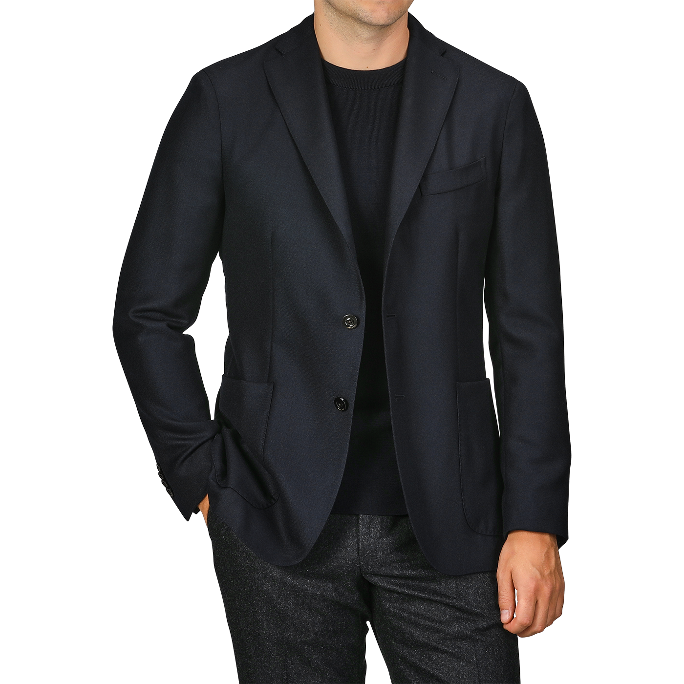 A person is seen wearing a Navy Blue Virgin Wool K Jacket by Boglioli over a black shirt, with their left hand in their trouser pocket. The trousers appear to be made of virgin wool and are grey. The person's head is not visible.