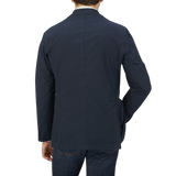 Man seen from behind wearing a Dark Blue Washed Cotton K Jacket by Boglioli with unstructured craftsmanship from Italy and denim jeans.